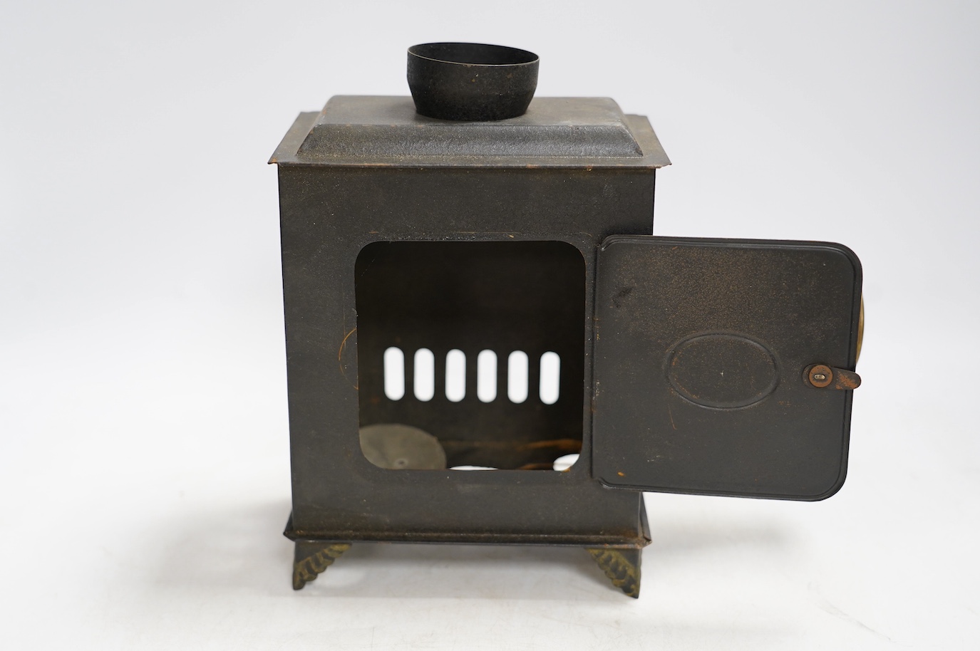 A late 19th century child's tinplate magic lantern with a selection of German slides, magic lantern 21cm high. Condition - fair to good